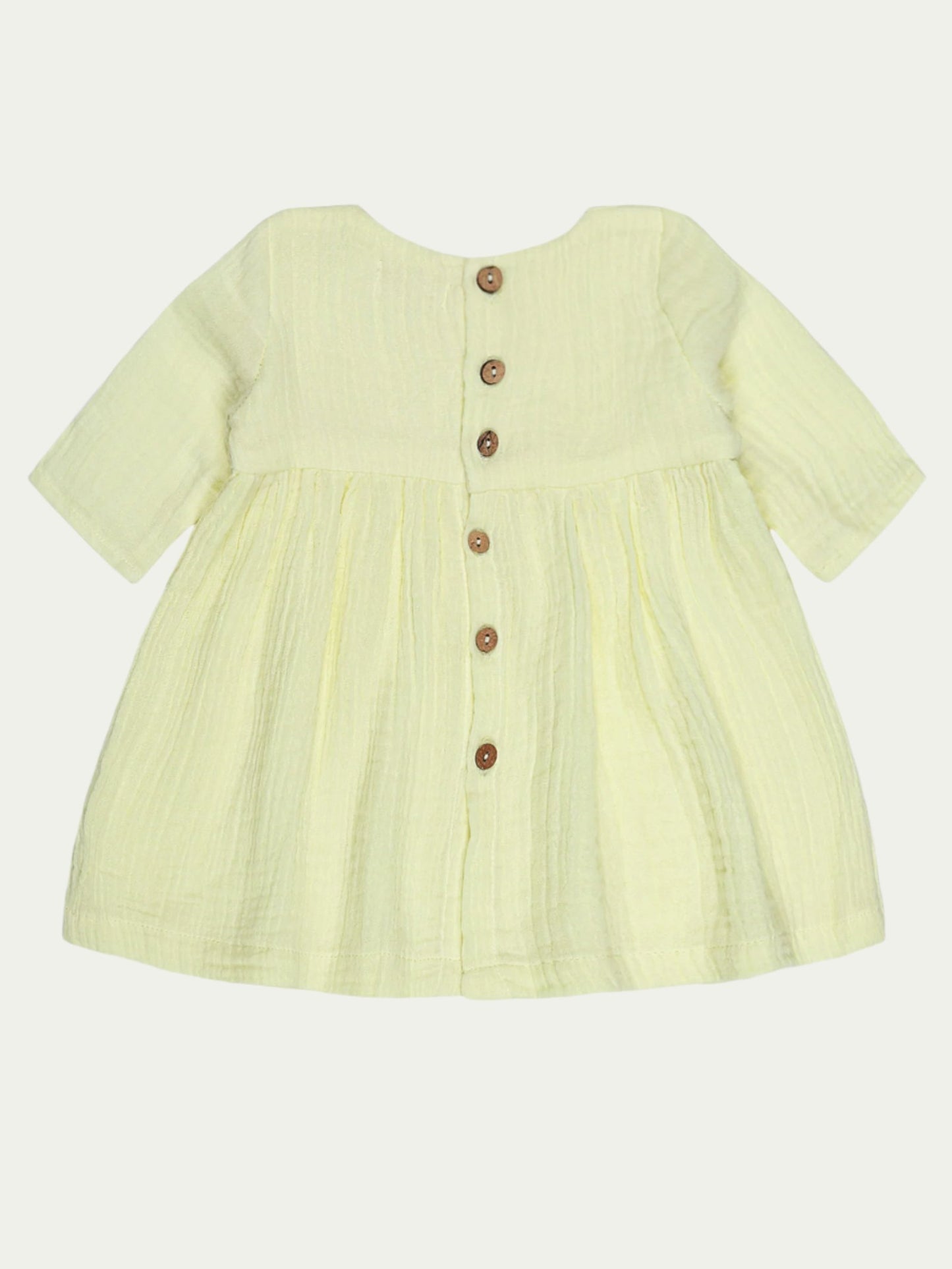 Back view of yellow organic cotton baby dress with long sleeves and pleated design – soft, breathable, and eco-friendly, perfect for babies aged 0-3 years by Ray&Baby.